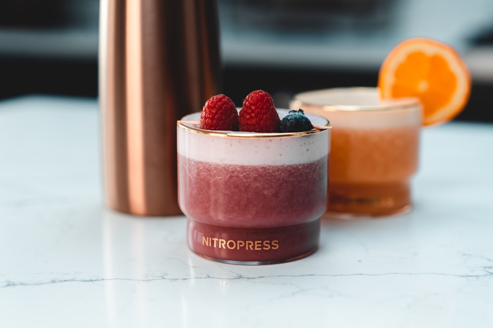 strawberry and blackberry on top of white table