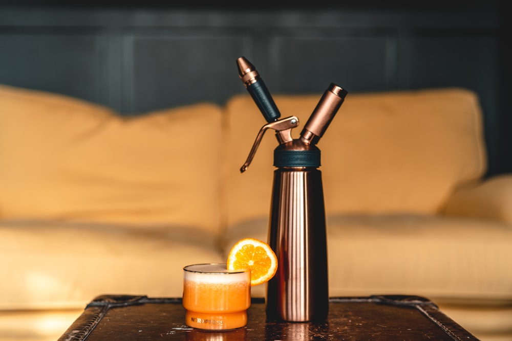 black and silver tube type vape beside orange candle