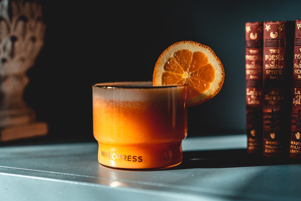 orange juice in clear drinking glass