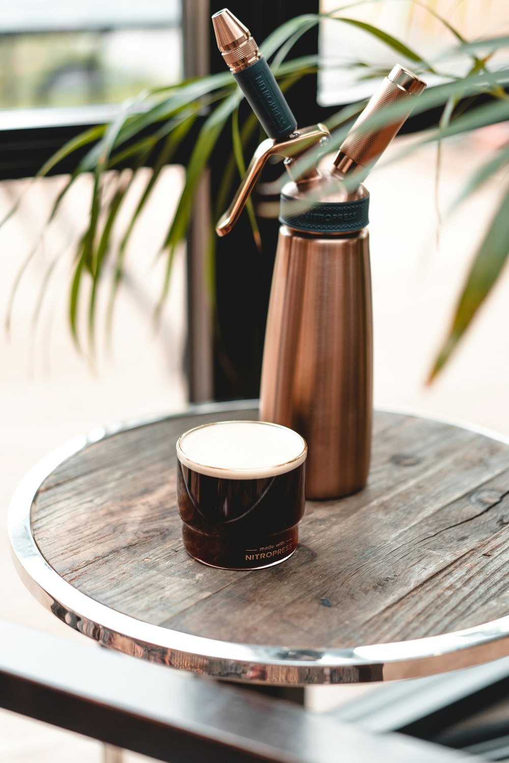 brown and white ceramic mug on brown wooden table