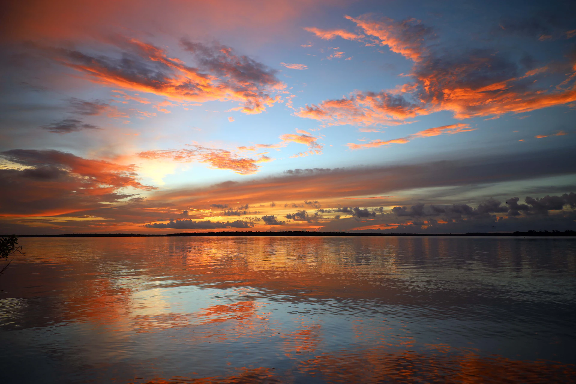 Sunset clouds reflected on calm water near Marco Island, Florida