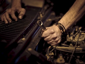 grayscale photo of person playing piano