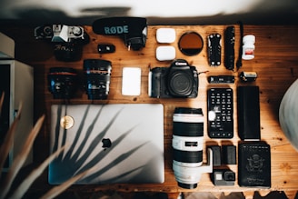 black dslr camera on brown wooden table