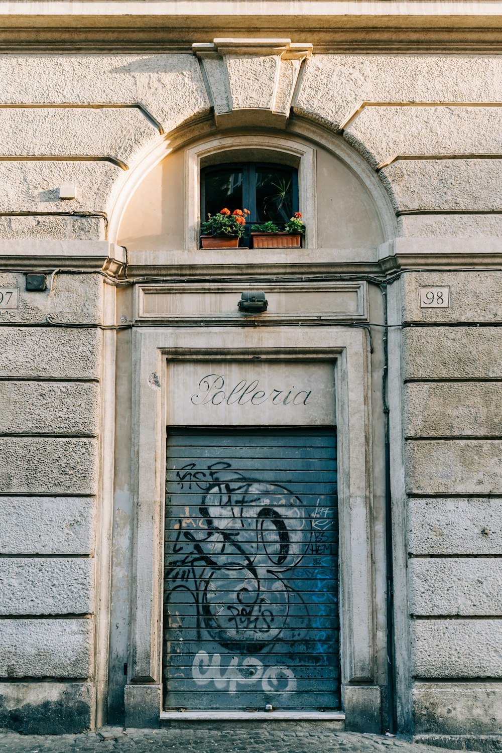 gray concrete building with black metal door