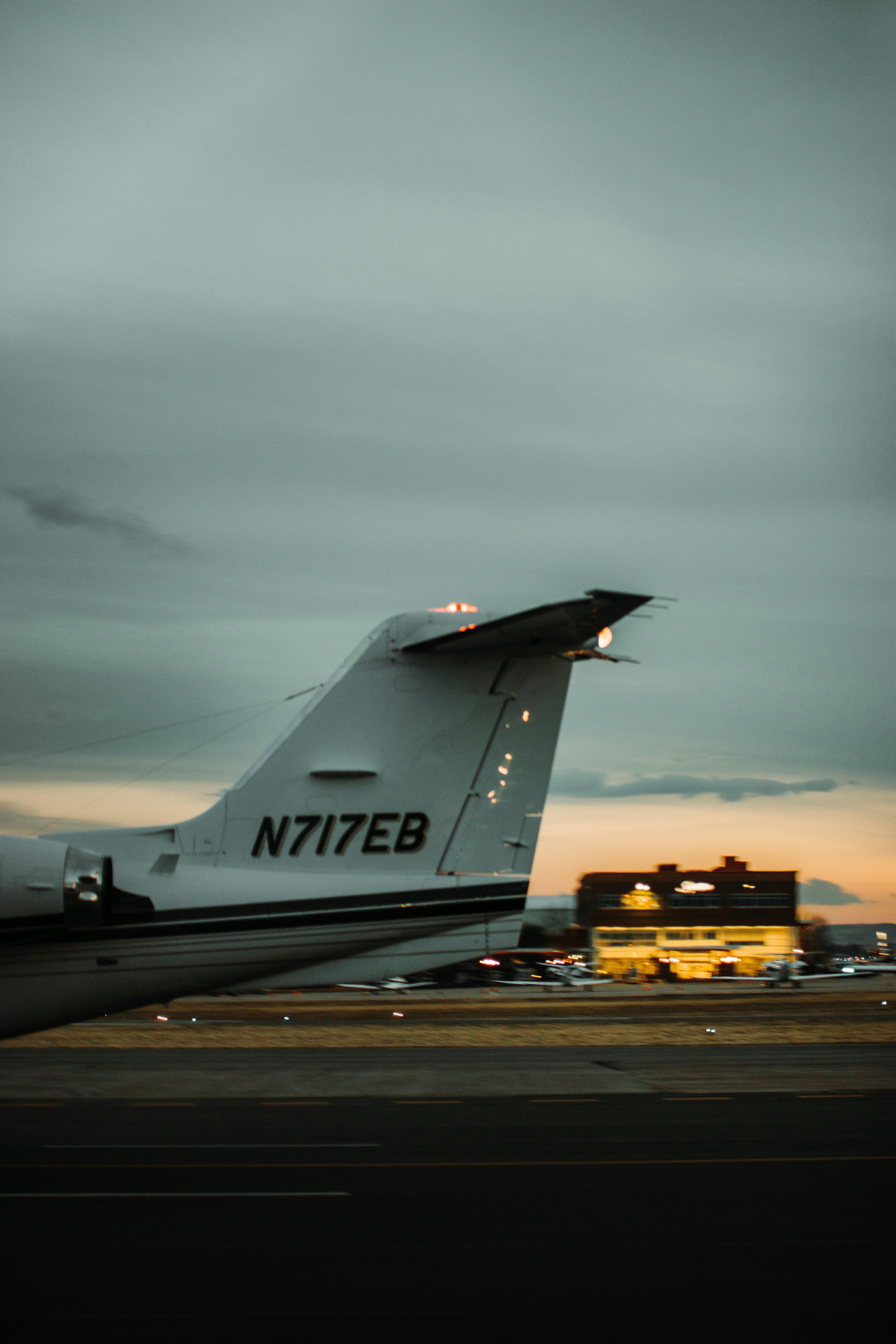 white and black airplane under gray clouds during daytime