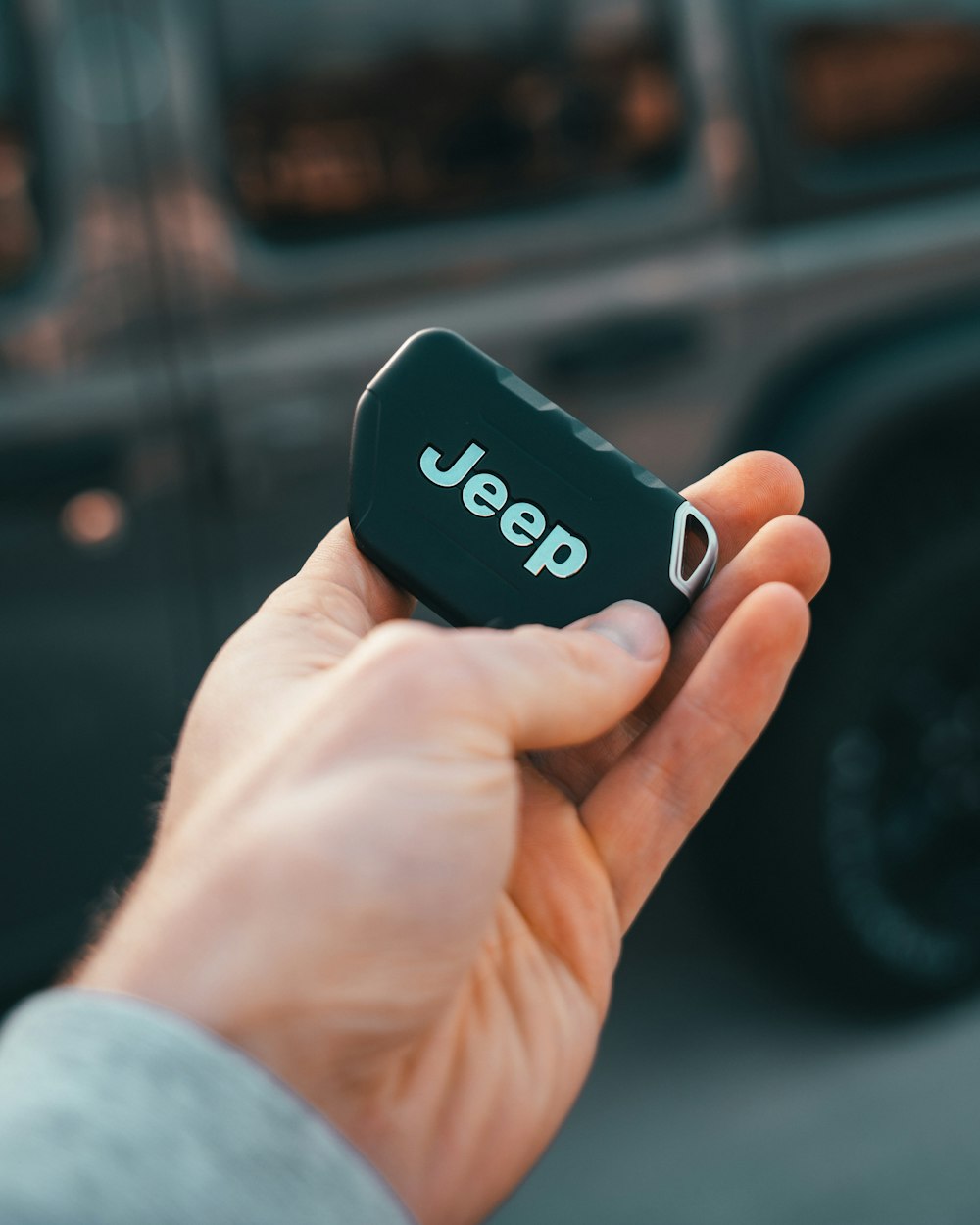 person holding black and white amazon echo dot