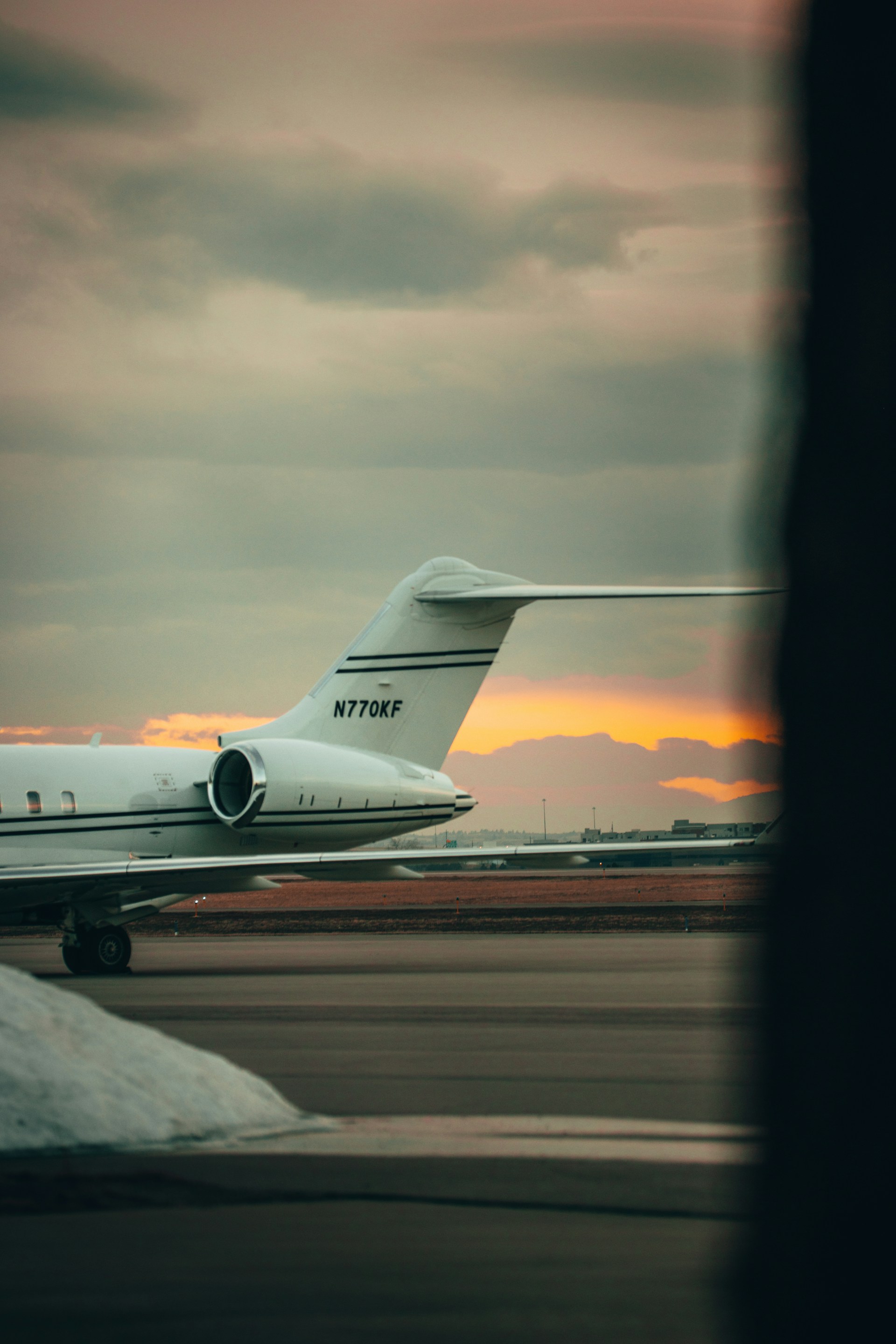 white passenger plane on airport during sunset