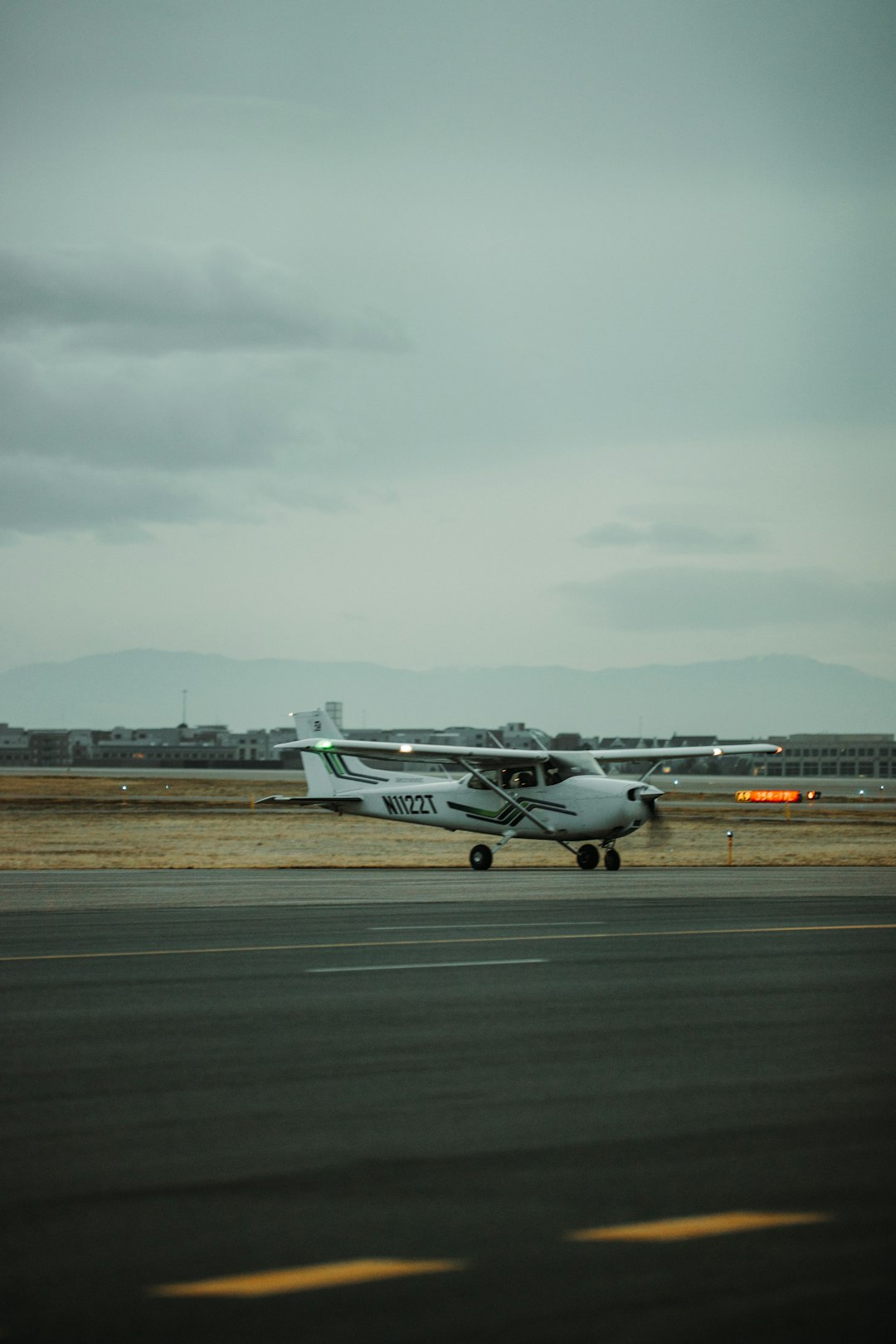 white and green airplane on airport during daytime