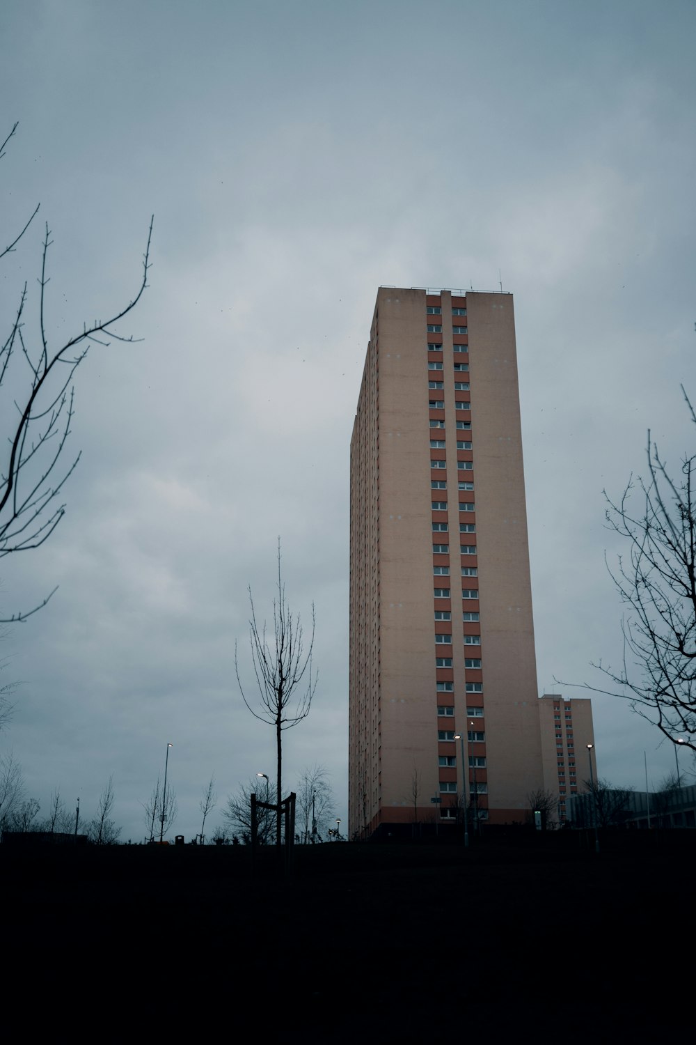 brown high rise building under gray sky