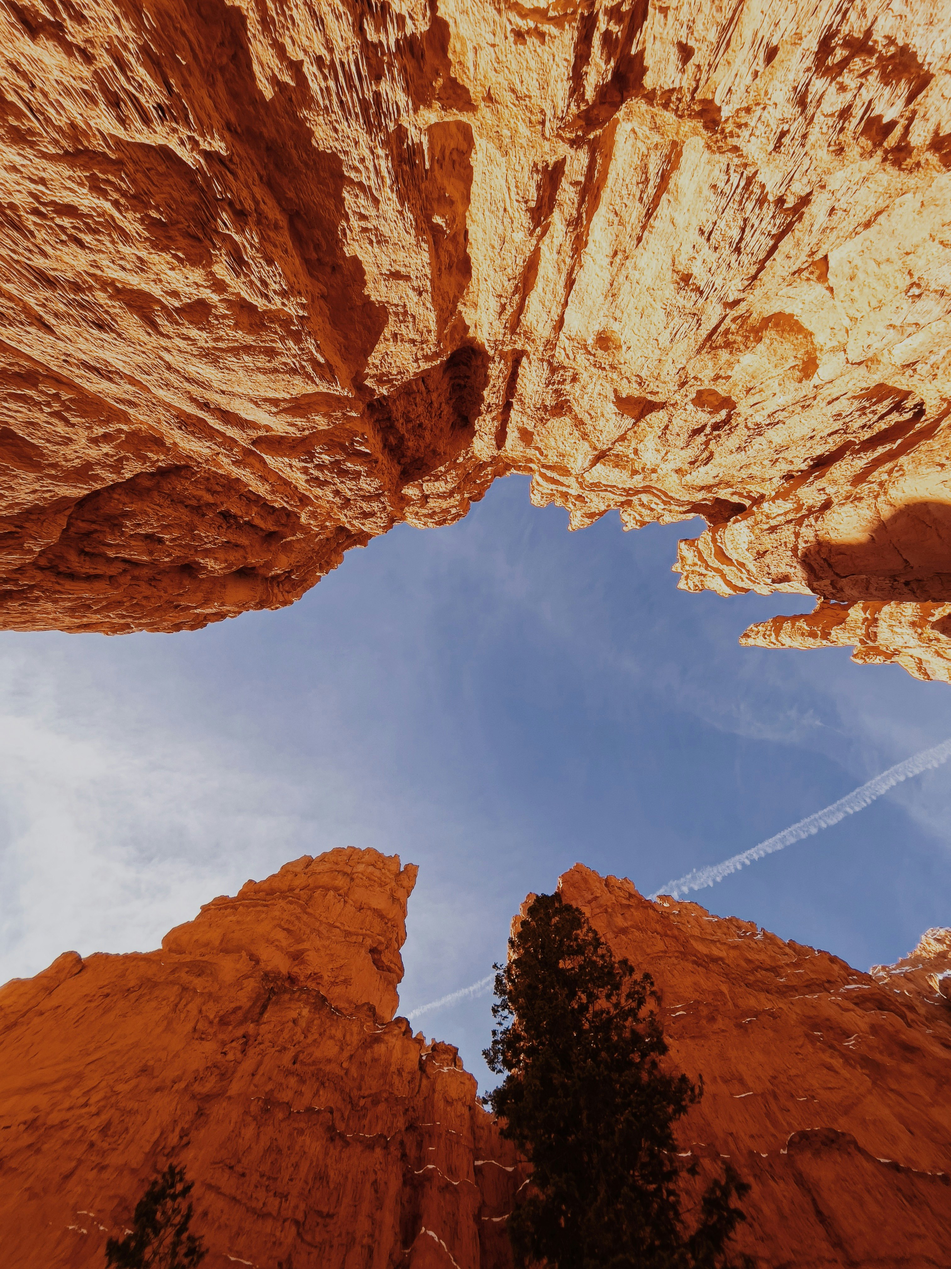 brown rock formation under blue sky and white clouds during daytime