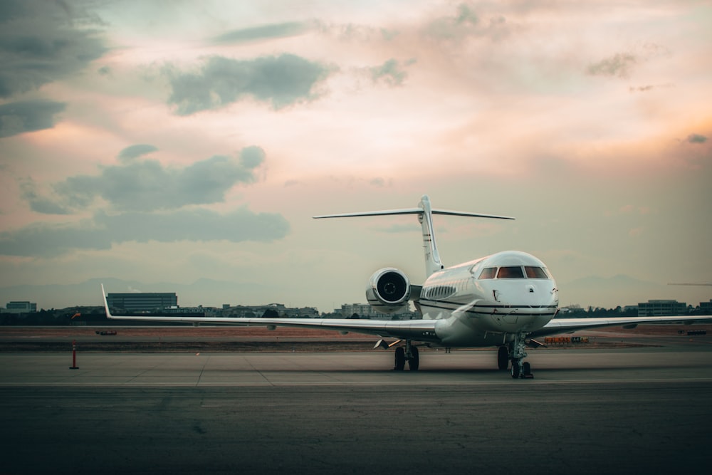 white airplane on airport during daytime