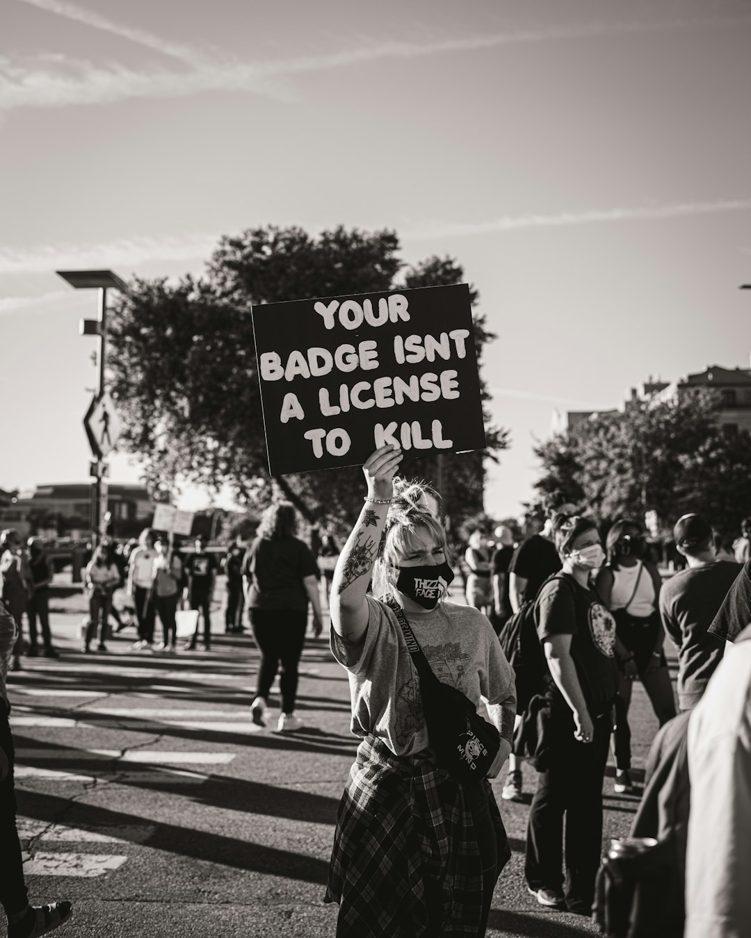 grayscale photo of people walking on pedestrian lane