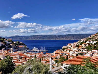 Hydra town from above, red roofs stacked around the harbour