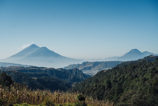 green mountains under blue sky during daytime in Volcán Atitlán Guatemala