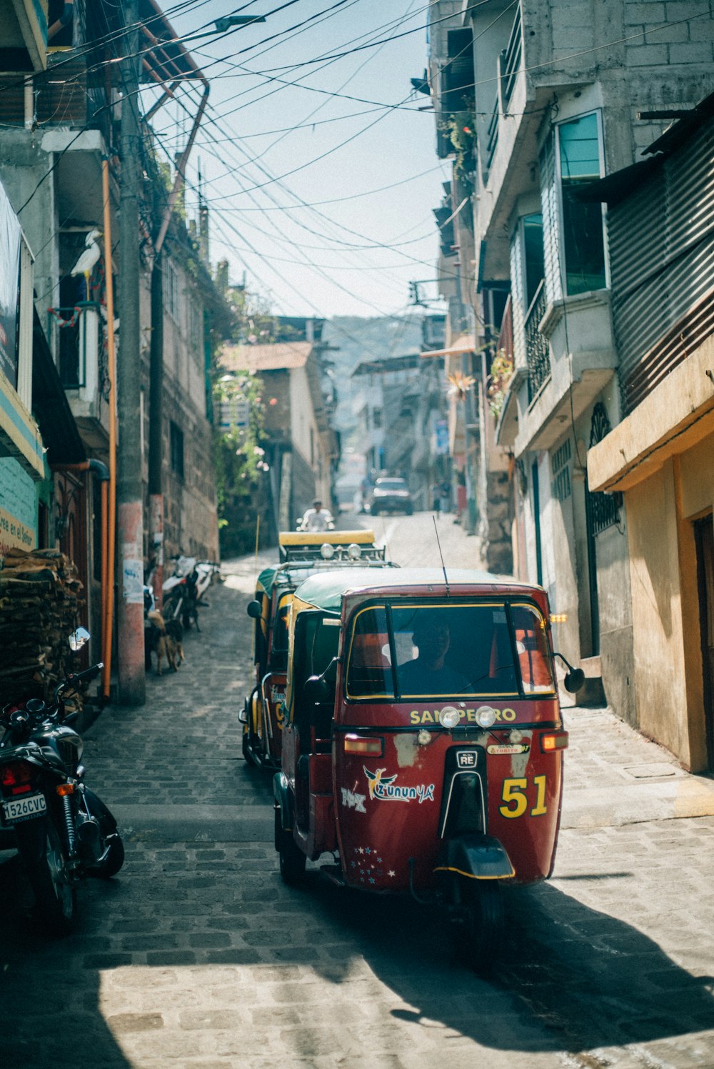 red and black mini cooper parked beside brown concrete building during daytime