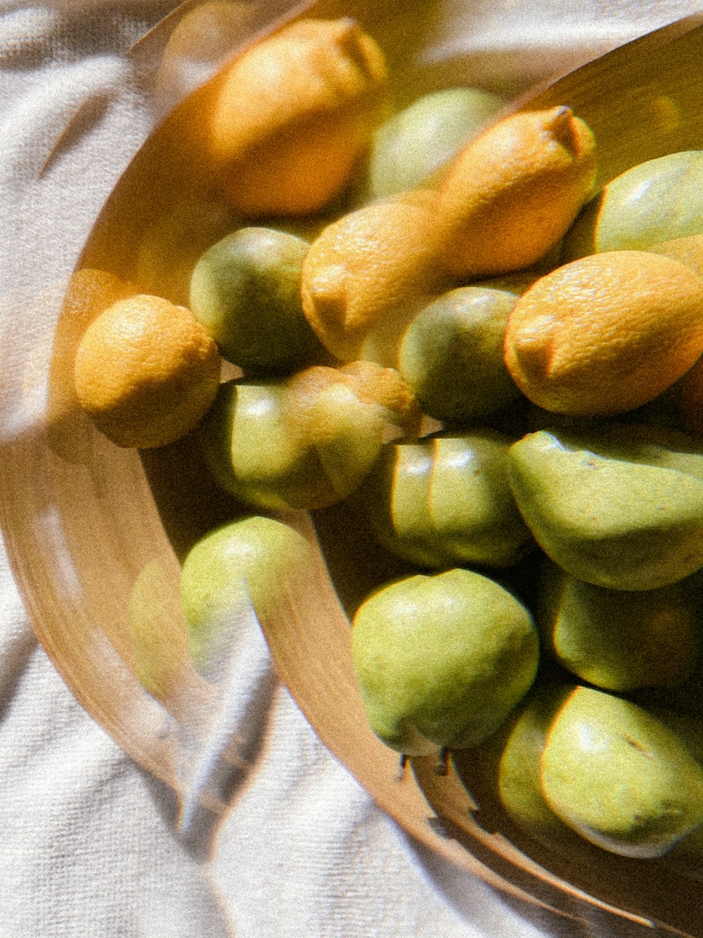 green round fruit on brown glass plate