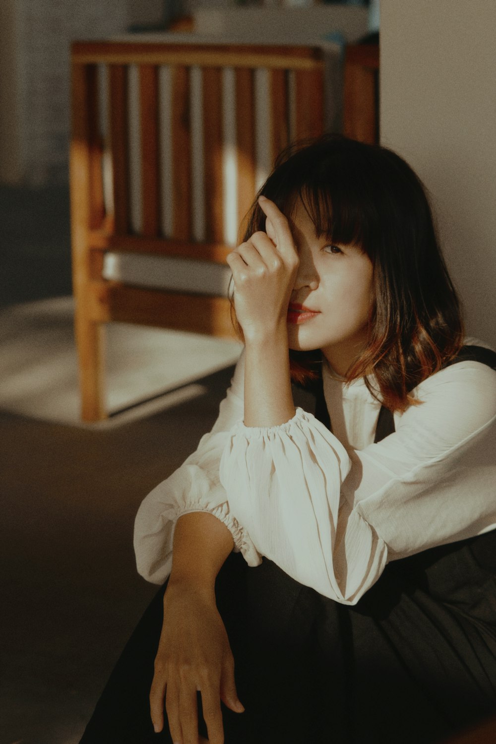 woman in white long sleeve shirt sitting on floor