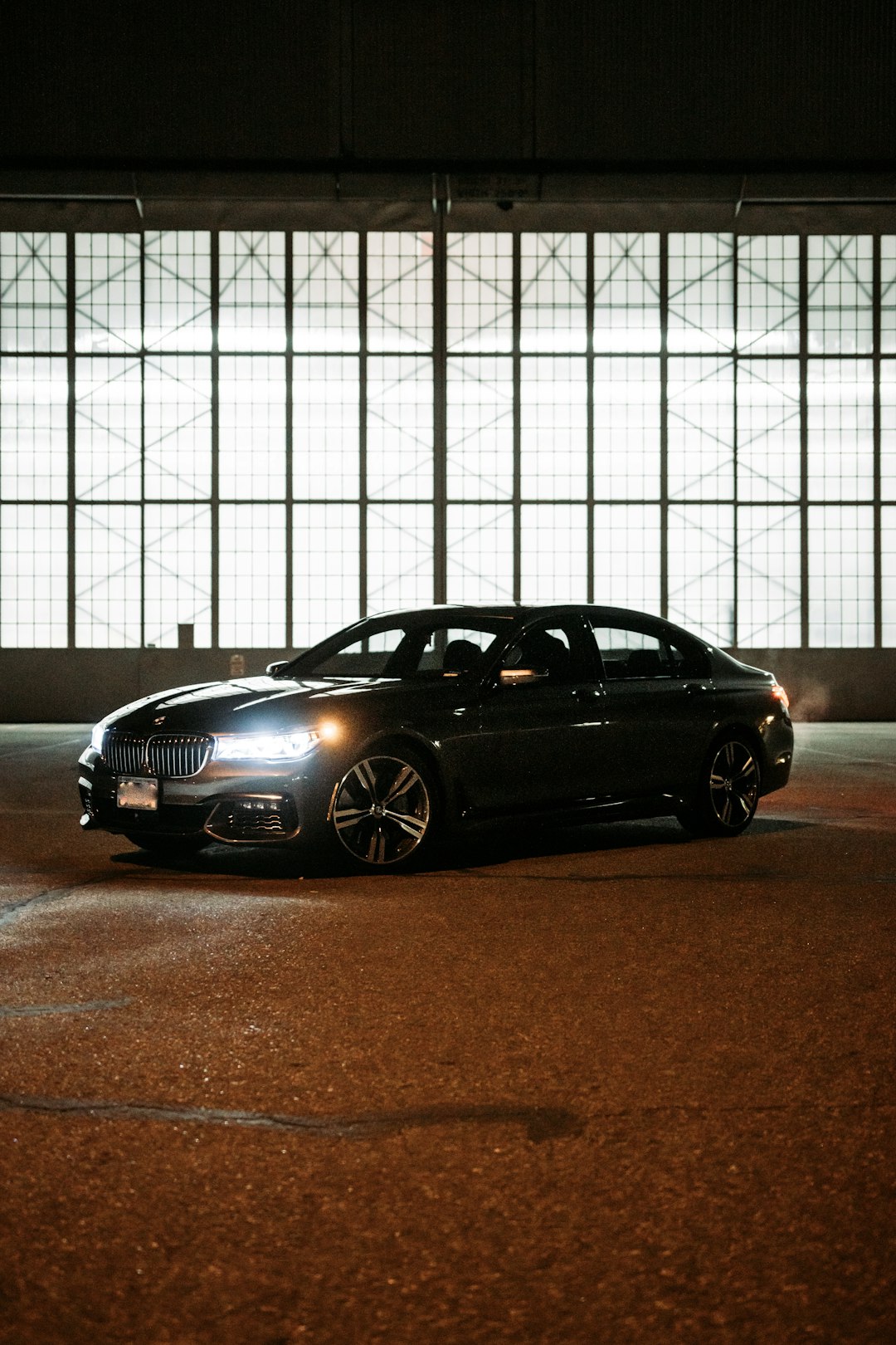 black bmw m 3 coupe parked beside white wall