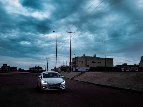 A beginner driver attentively practicing parking in a quiet urban street.