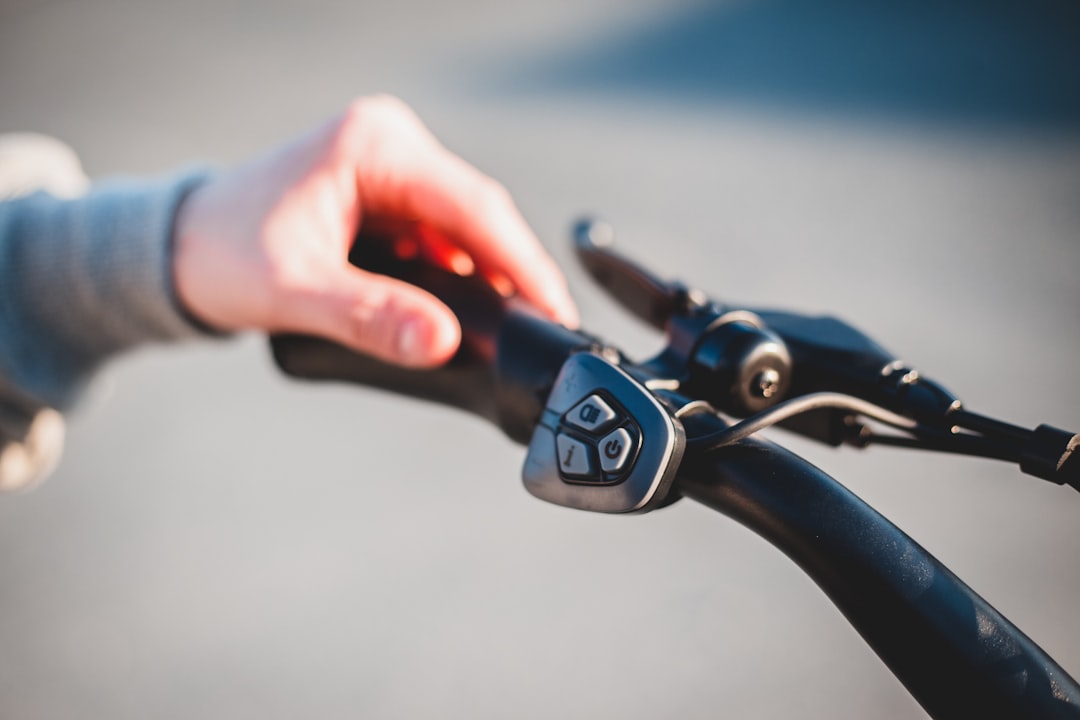 person holding black bicycle handle bar