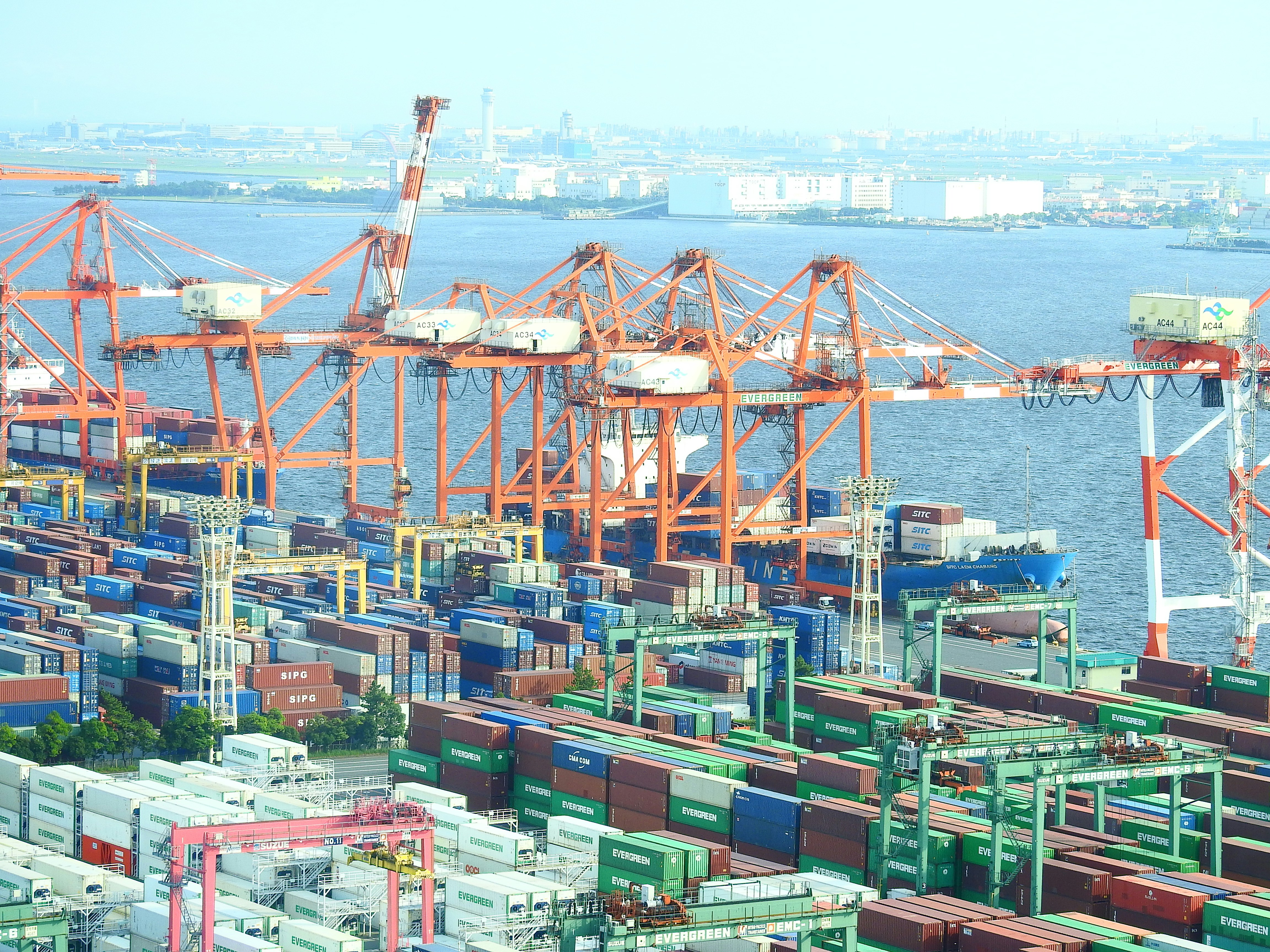 blue and red cargo ship on sea during daytime