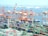 A busy shipping port with containers being loaded onto trucks and trains.