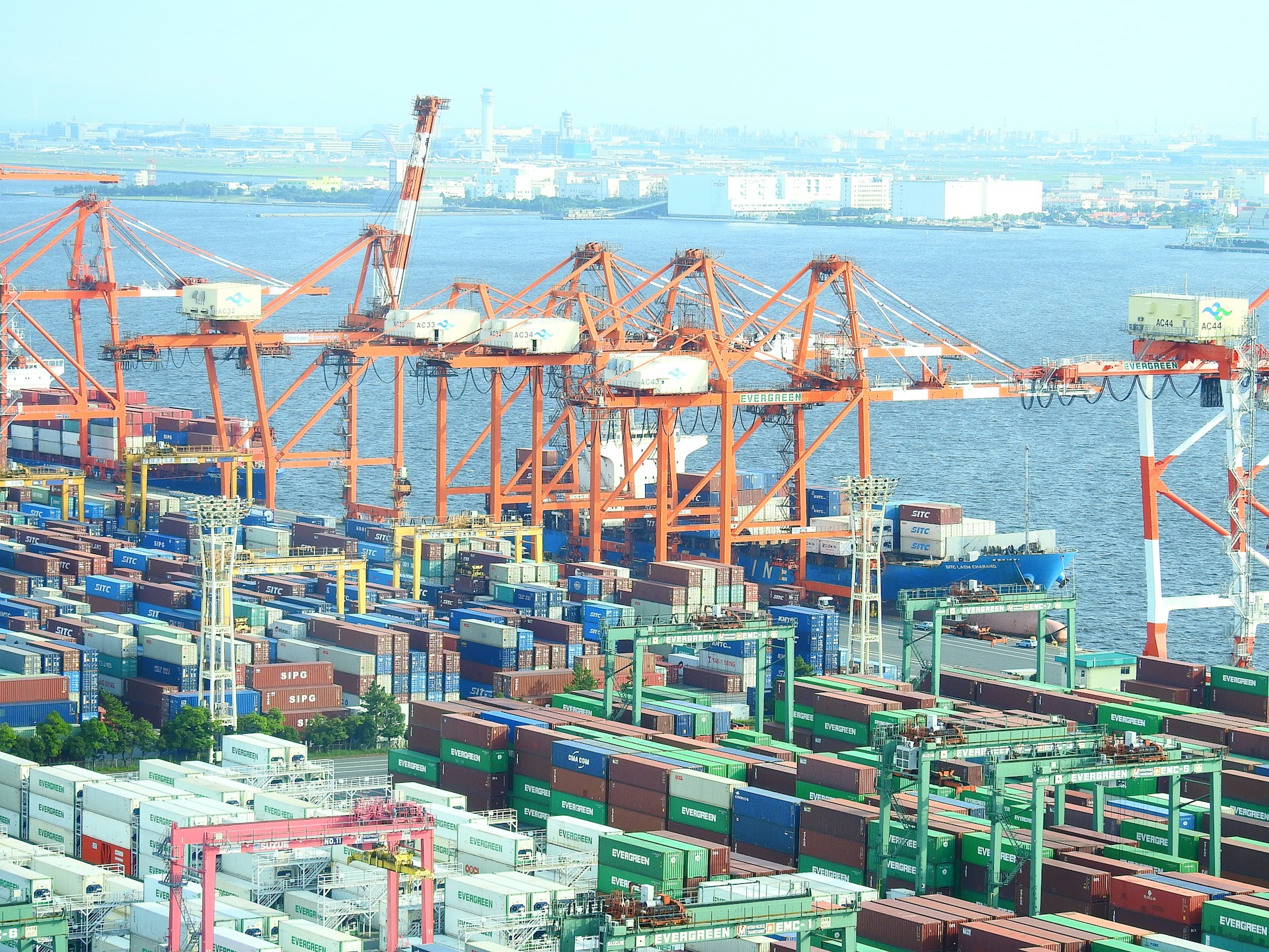 blue and red cargo ship on sea during daytime