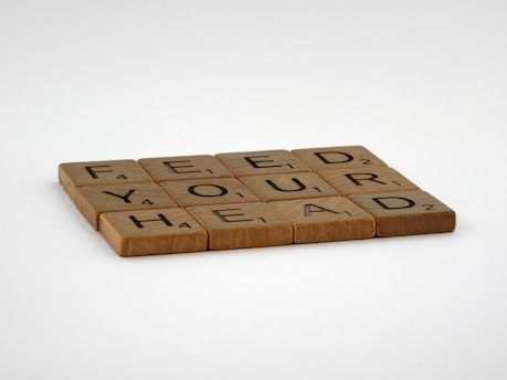 brown wooden letter blocks on white surface
