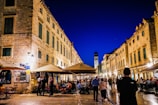 Historic city square glowing warmly in the evening light with lively cafes.