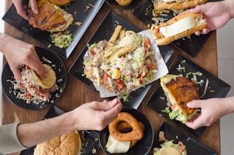 person holding bread with vegetable salad