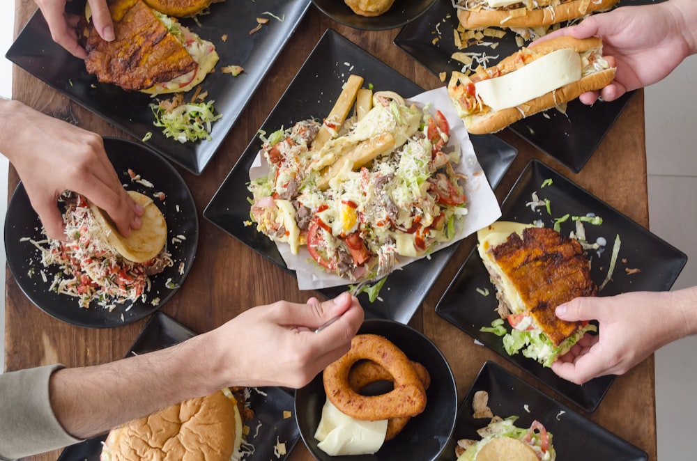 person holding bread with vegetable salad