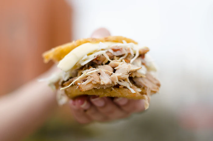 Arepa venezolana rellena de mechada y queso de mano