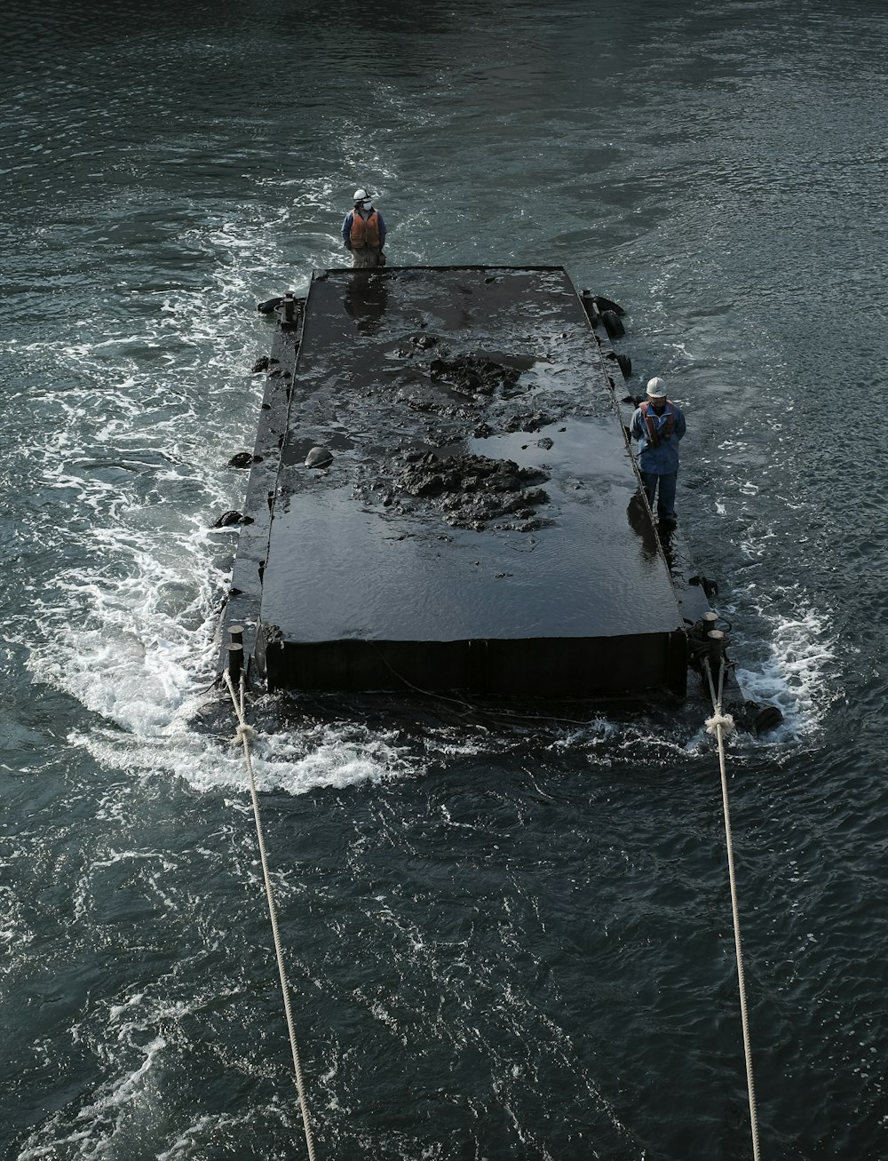 people on black boat on sea during daytime