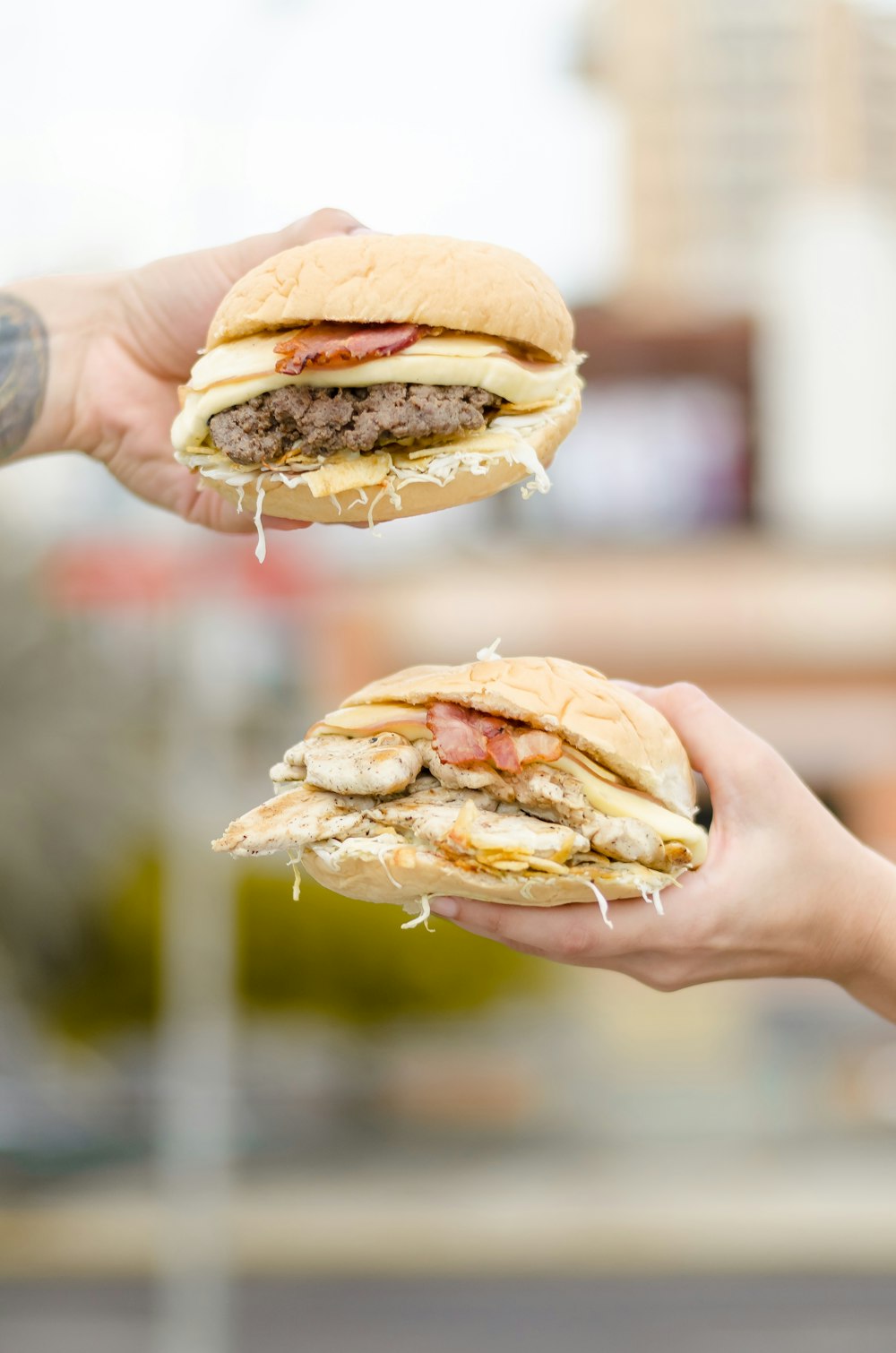 person holding burger with cheese