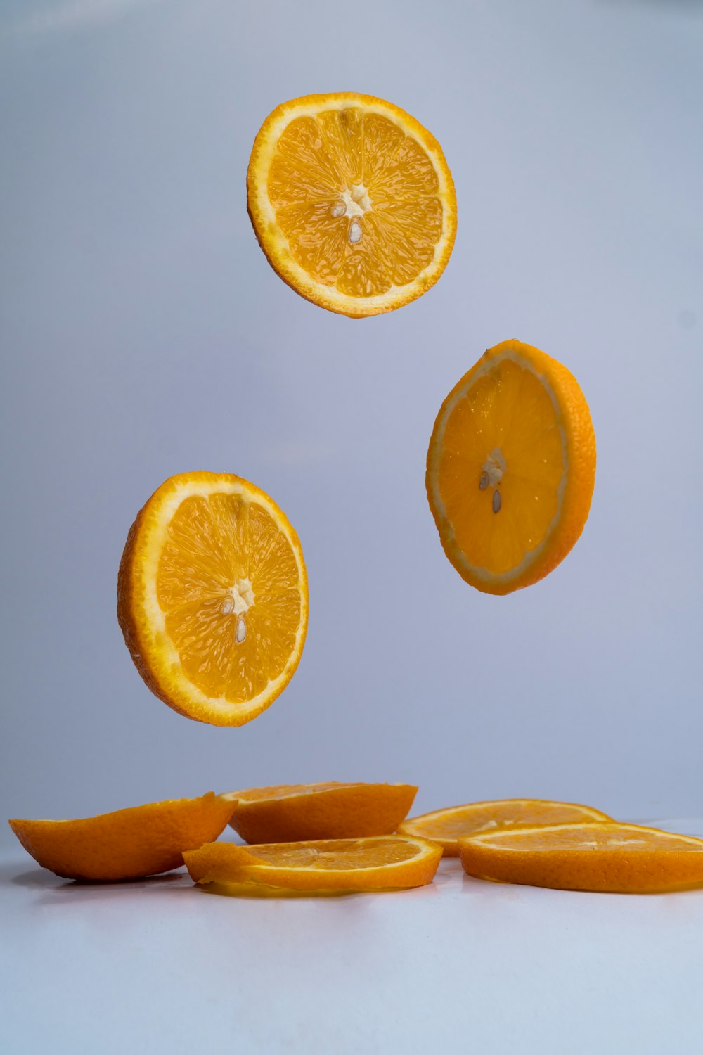 sliced orange fruit on blue surface