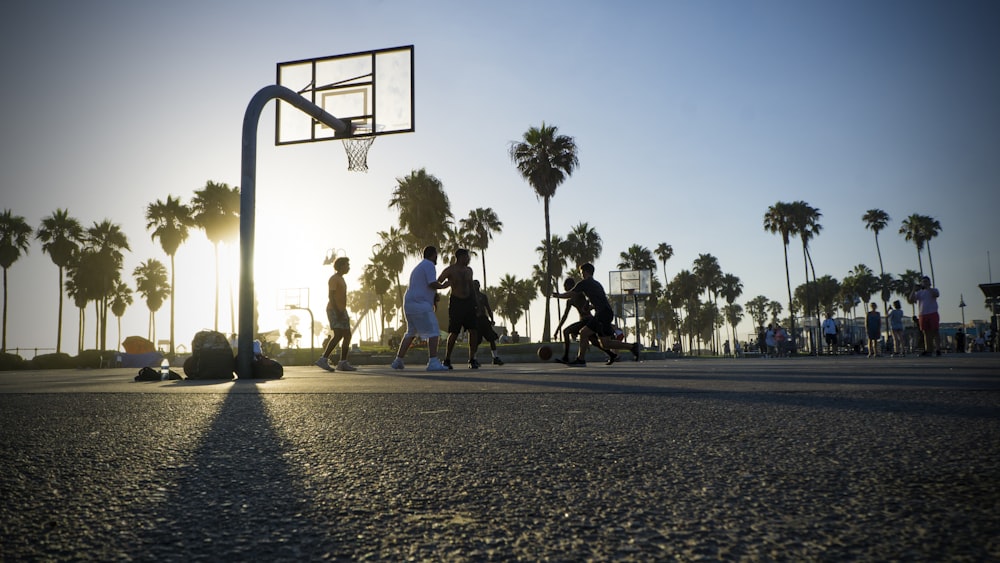 people walking on basketball court during daytime