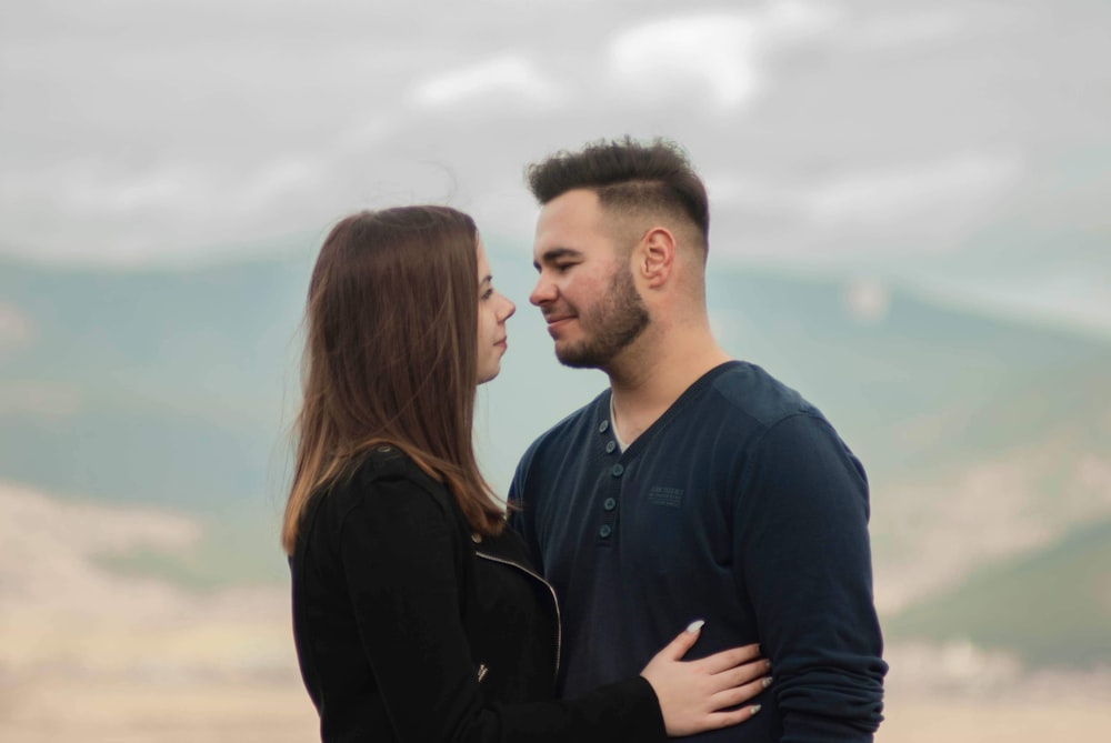 man in black long sleeve shirt kissing woman in black long sleeve shirt