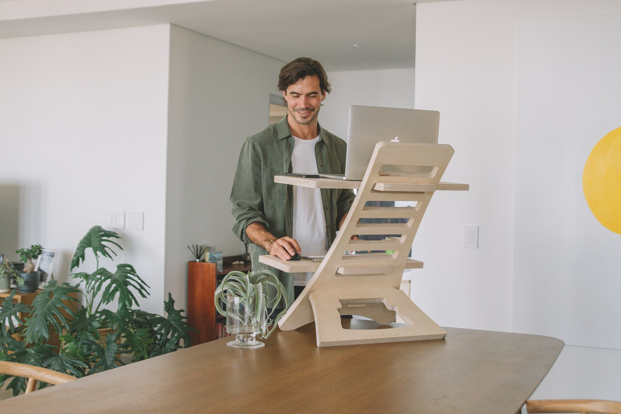 man working at a standing desk converter