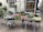 A charming outdoor flower shop displays an array of vibrant plants and flowers. The scene includes various pots filled with blooming flowers and lush greenery. The shop's window showcases decorative vases and floral arrangements, creating an inviting and colorful environment.