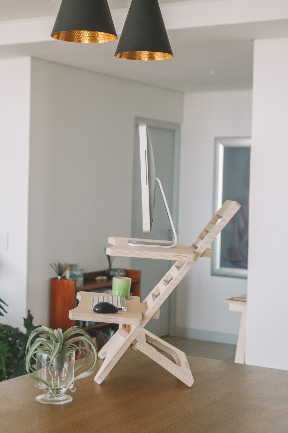 brown wooden table beside white wall