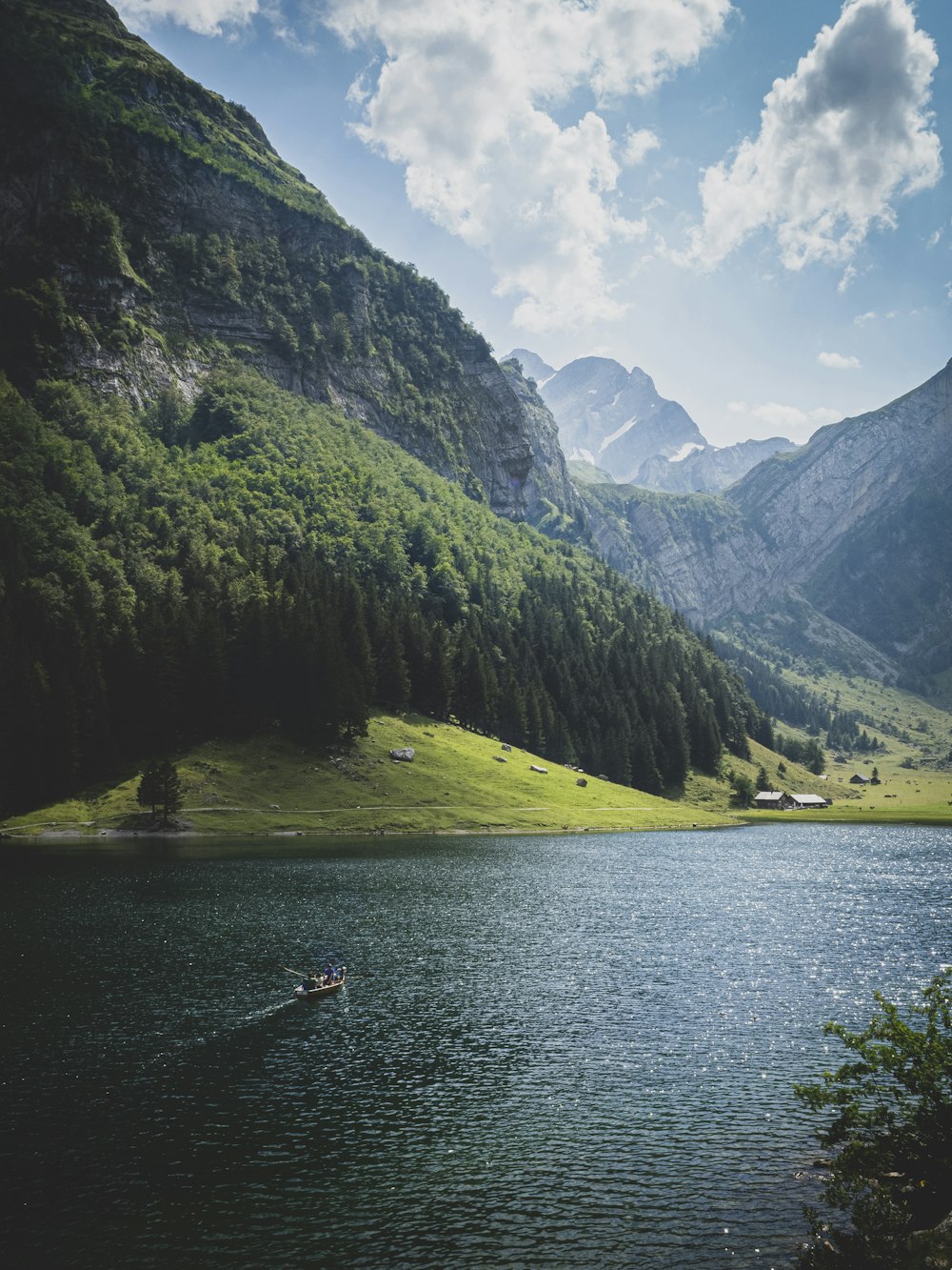 green mountains beside body of water during daytime