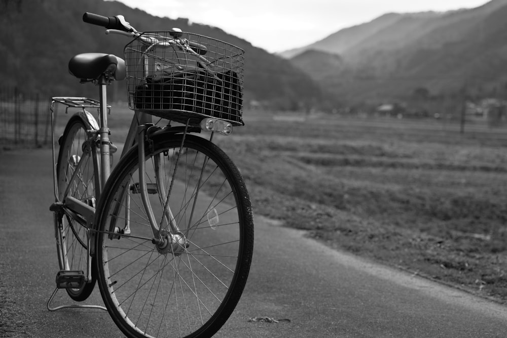 grayscale photo of city bicycle on road
