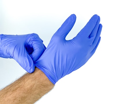 person in blue shorts showing right hand