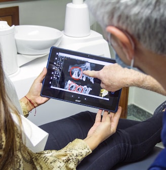 woman in blue denim jeans holding black tablet computer