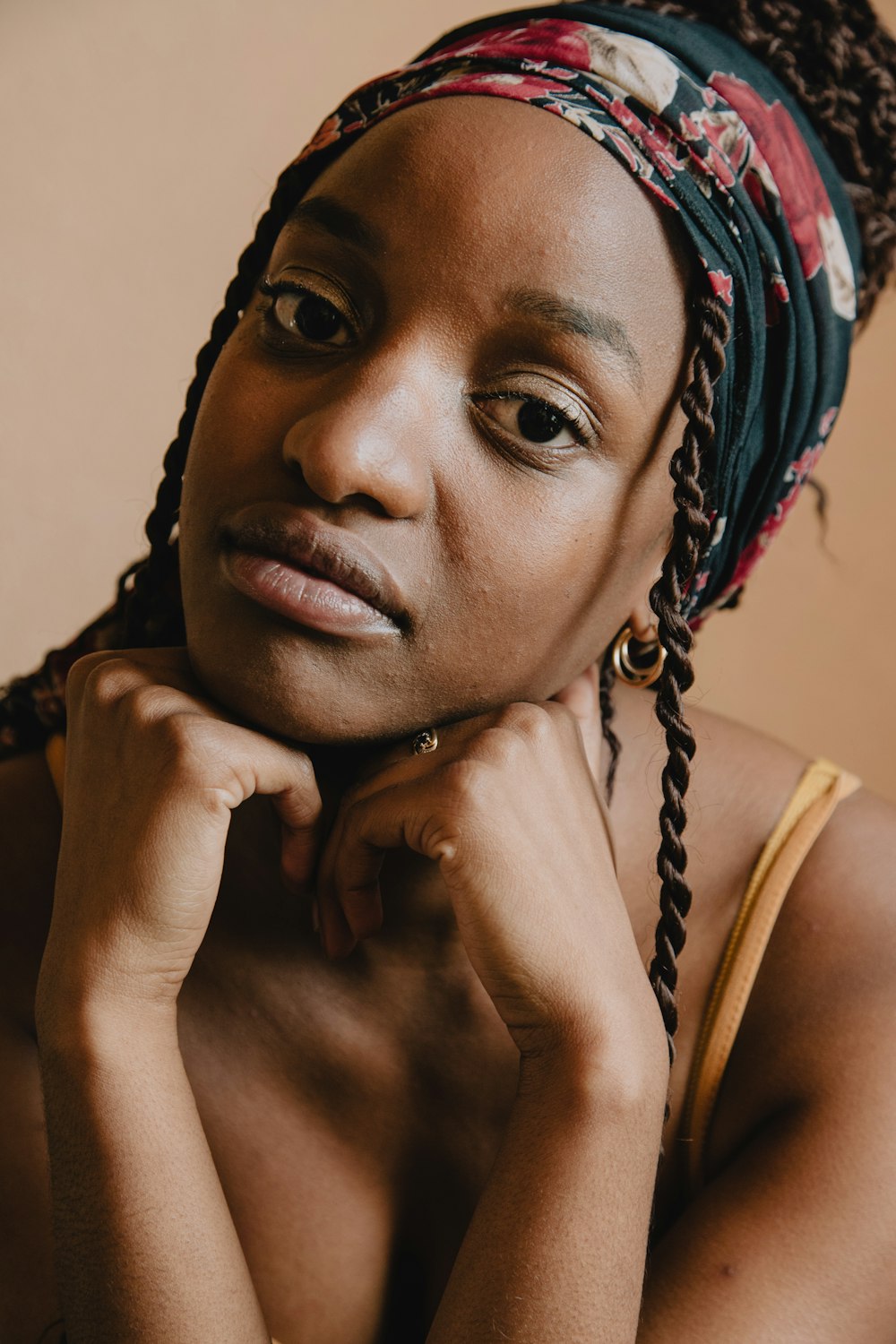 woman in white tank top wearing blue and white floral head scarf