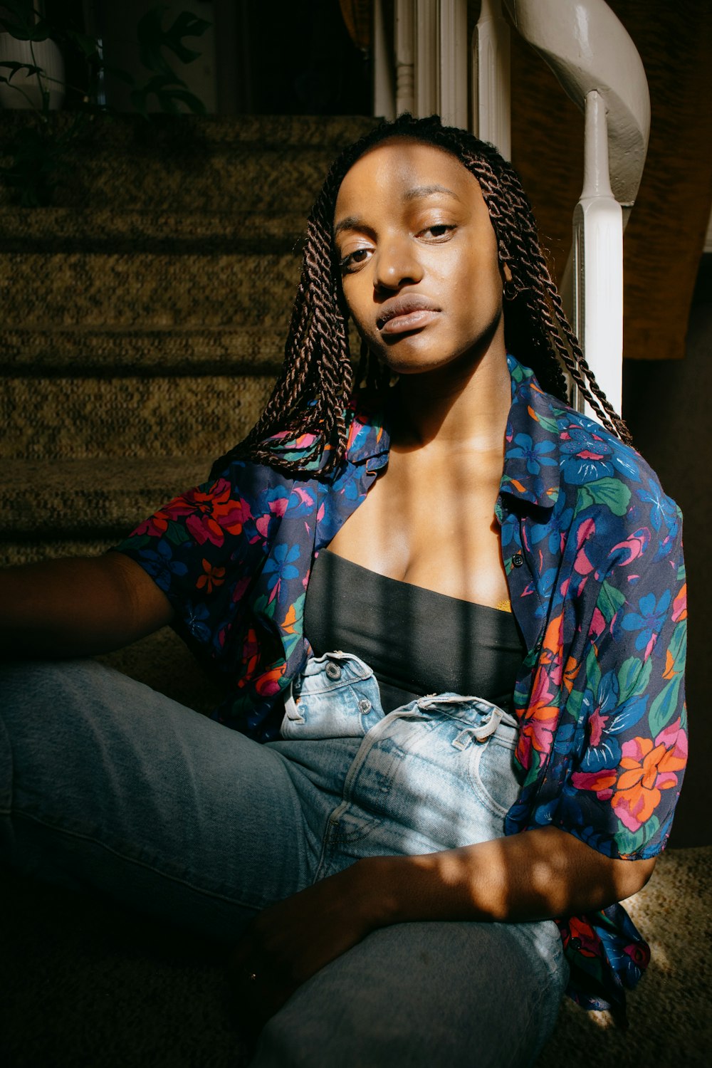 woman in blue red and green floral button up shirt and blue denim jeans