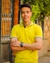man in yellow polo shirt wearing black round analog watch