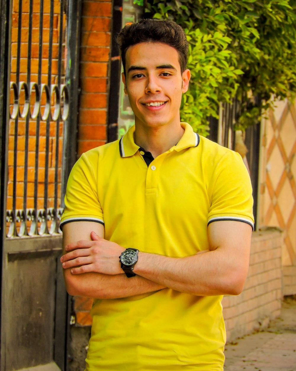 man in yellow polo shirt wearing black round analog watch