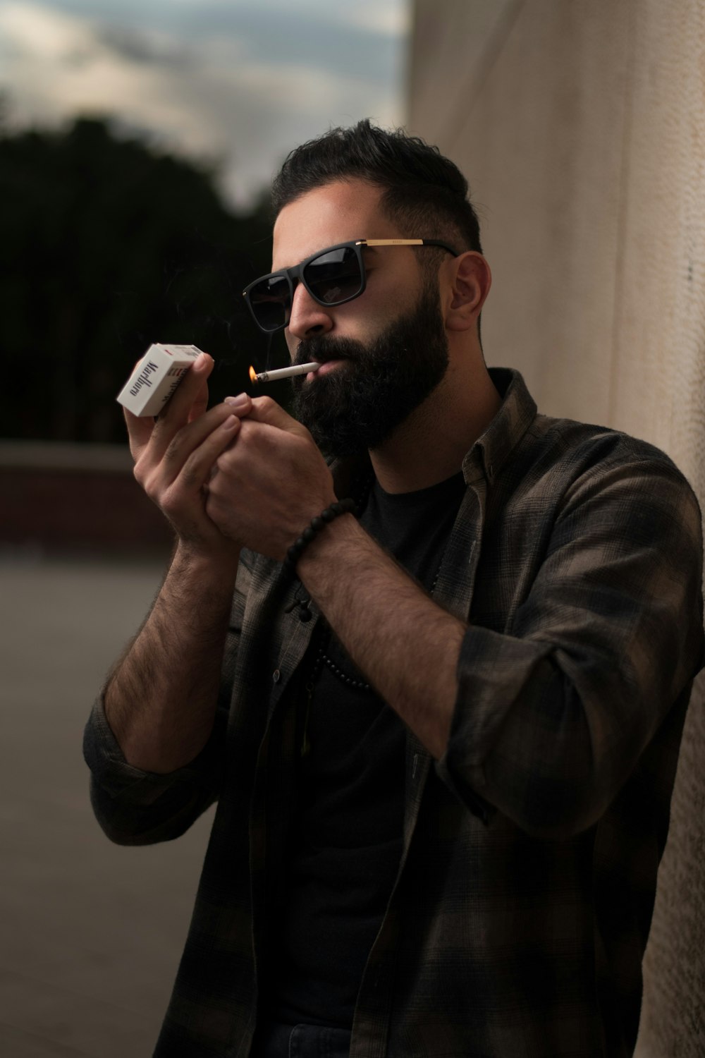 man in brown button up shirt smoking cigarette