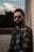man in black sunglasses and gray and black plaid button up shirt